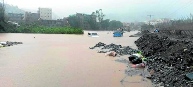 DELUGE IN THE NORTH Torrential rains and gusty winds whipped up by Typhoon “Egay” (international name: Doksuri) left a trail of destruction across northern Luzon on Wednesday. In La Trinidad, Benguet, a stretch of Pines Park Diversion Road has gone underwater and the province is “in dire need of help,” according to Benguet Rep. Eric Yap. At least five deaths were attributed to Egay, based on reports gathered by the Inquirer. The National Disaster Risk Reduction and Management Council reported one fatality and two injuries as of press time. —PHOTO FROM LA TRINIDAD MUNICIPAL GOVERNMENT