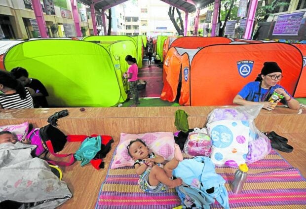AS FELT IN QC Some Quezon City residents take shelter at Barangay Bagong Silangan Elementary School on Thursday after fleeing flash floods triggered by “Egay” in various parts of Metro Manila. —MARIANNE BERMUDEZ