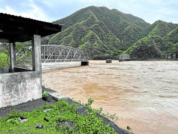 ILOCOS SUR CUTOFF Quirino Bridge in Bantay town, Ilocos Sur, had two sections washed away by the swelling, raging river, its water thickened with mud, during the onslaught of Typhoon “Egay” in northern Luzon on Wednesday. Among the worst hit by the typhoon, Ilocos Sur and neighboring Ilocos Norte have been declared under a state of calamity. —John Noel Andaya/CONTRIBUTOR
